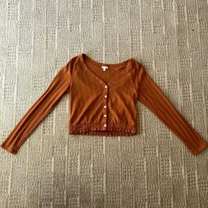 A small cropped long sleeve knitted top from Self Esteem in a size small